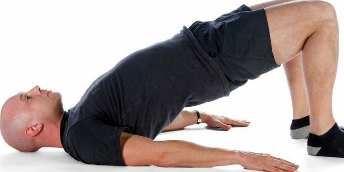 Performing the Arch exercise by a man to increase potency
